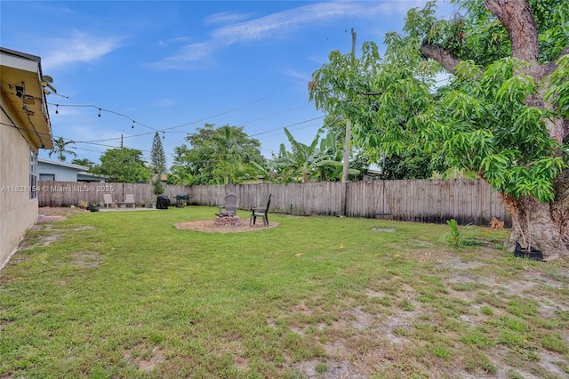 2041 Arcadia Dr, Miramar, FL 33023 - fenced backyard featuring an outdoor fire pit