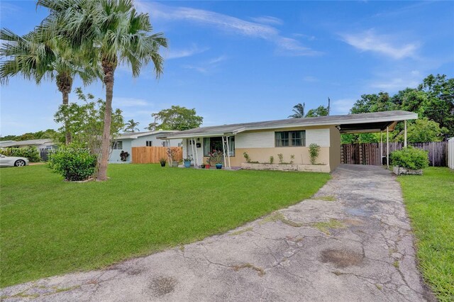 2041 Arcadia Dr, Miramar, FL 33023 - ranch-style house featuring asphalt driveway and an attached carport