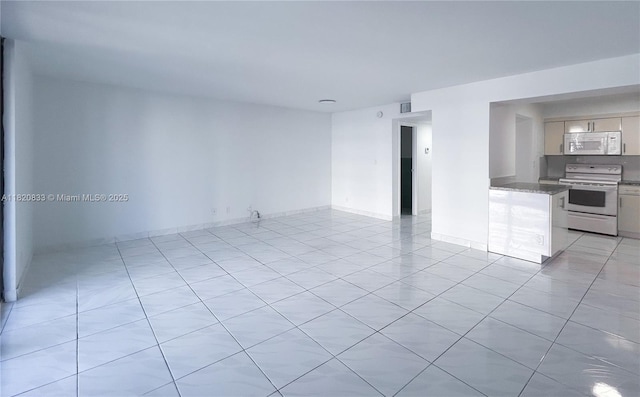 1800 Collins Ave Unit 5C, Miami Beach, FL 33139 - spare room with light tile patterned floors and baseboards