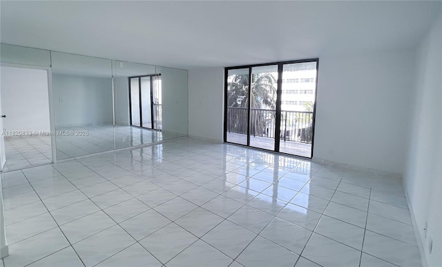 1800 Collins Ave Unit 5C, Miami Beach, FL 33139 - empty room with light tile patterned floors and a wall of windows