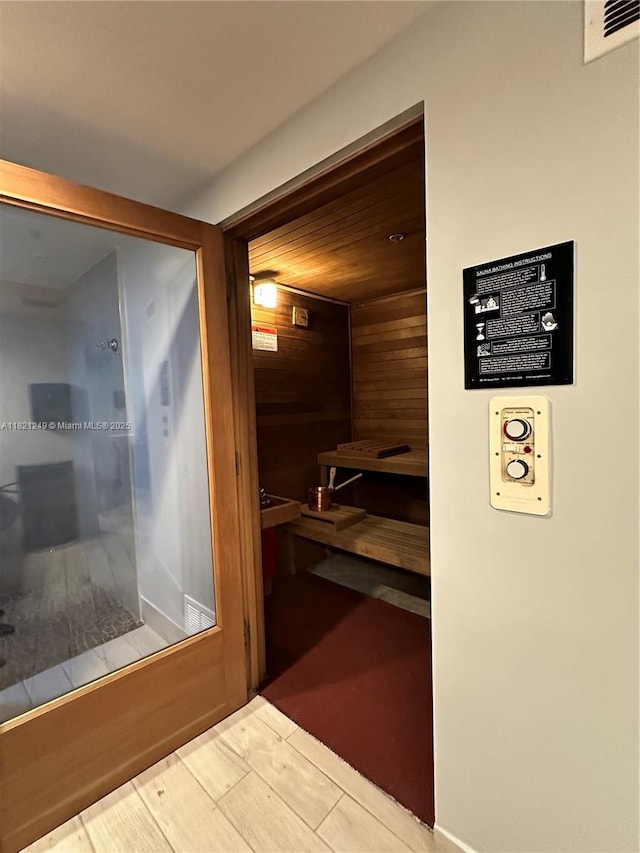 relaxing sauna / steam room featuring wooden walls