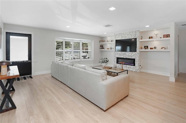9627 SW 18th Ter, Miami, FL 33165 - living room with a stone fireplace, light wood finished floors, and recessed lighting