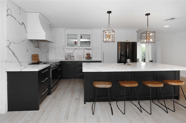 9627 SW 18th Ter, Miami, FL 33165 - kitchen featuring stainless steel electric range oven, custom range hood, black refrigerator with ice dispenser, dark cabinetry, and white cabinets