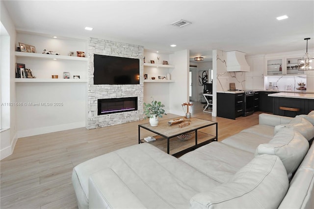 9627 SW 18th Ter, Miami, FL 33165 - living area featuring light wood finished floors, a fireplace, and built in features
