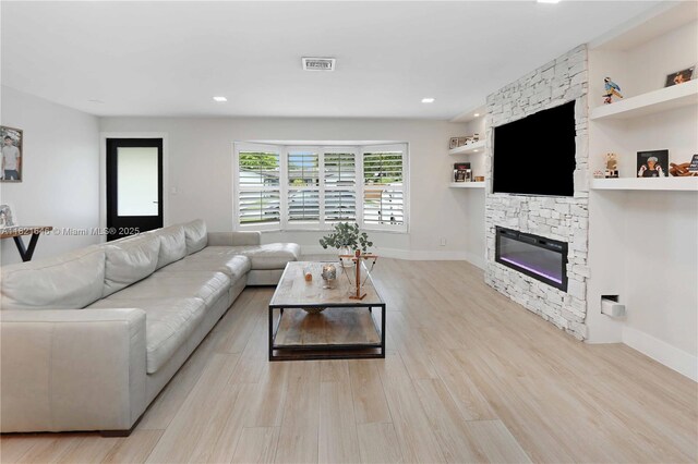 9627 SW 18th Ter, Miami, FL 33165 - living area with light wood finished floors, a stone fireplace, and recessed lighting
