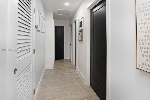 9627 SW 18th Ter, Miami, FL 33165 - bedroom with light wood-style flooring, a barn door, and connected bathroom
