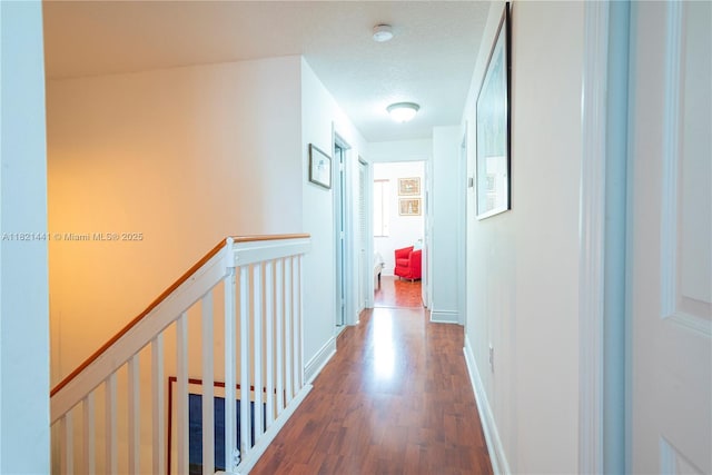 15285 SW 30th Ter, Miami, FL 33185 - hallway with an upstairs landing, wood finished floors, and a textured ceiling