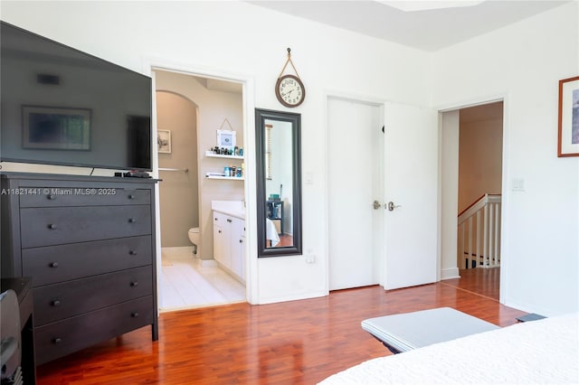 15285 SW 30th Ter, Miami, FL 33185 - bedroom featuring wood finished floors, a closet, arched walkways, and ensuite bathroom