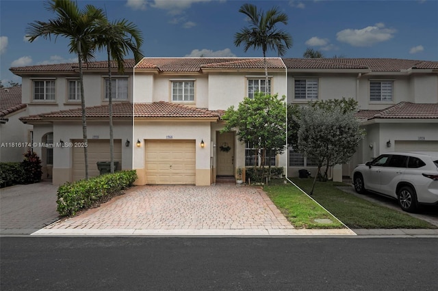1968 NW 79th Way, Pembroke Pines, FL 33024 - view of front of house with stucco siding, decorative driveway, a tile roof, and an attached garage