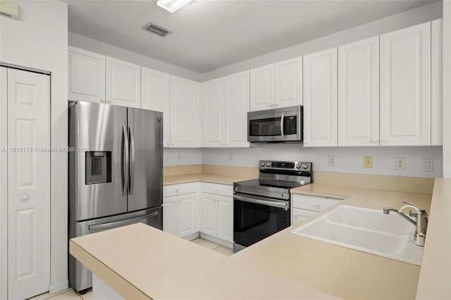 1968 NW 79th Way, Pembroke Pines, FL 33024 - kitchen featuring stainless steel appliances, white cabinets, light countertops, and a peninsula