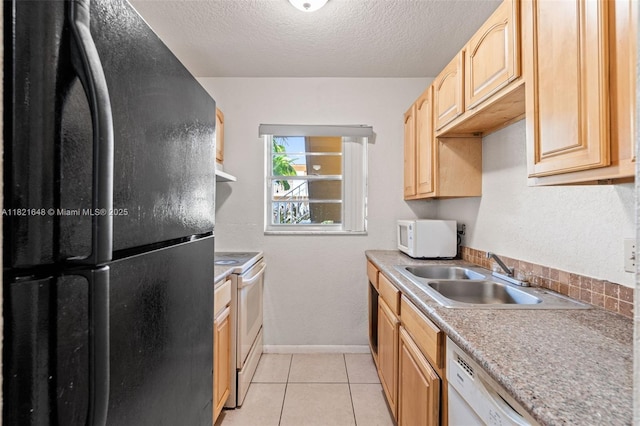 200 Croton Ave Unit 102, Lantana, FL 33462 - kitchen featuring white appliances, a textured ceiling, light brown cabinets, light tile patterned floors, and light countertops