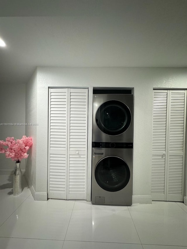 6315 SW 138th Ct Unit 6315-4, Miami, FL 33183 - laundry room featuring stacked washing machine and dryer, tile patterned floors, and a textured wall