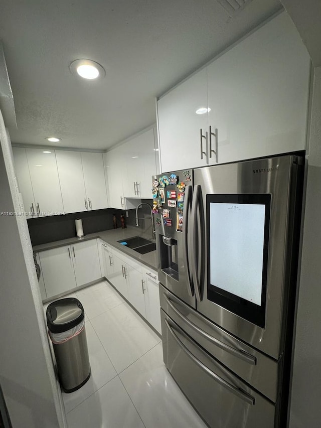 6315 SW 138th Ct Unit 6315-4, Miami, FL 33183 - kitchen with stainless steel refrigerator with ice dispenser, white cabinetry, and light tile patterned flooring