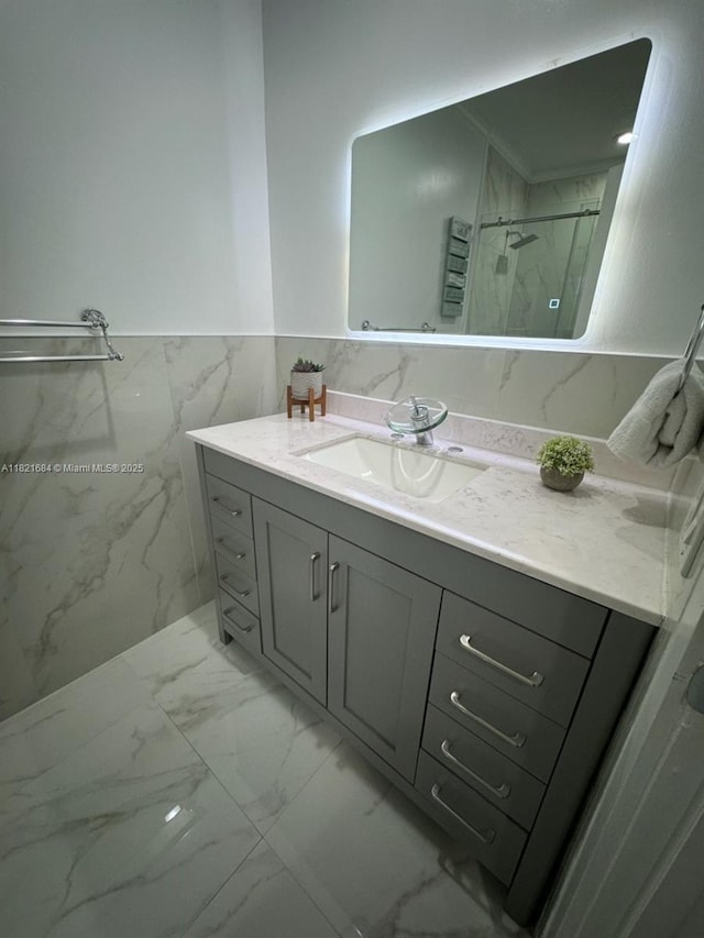 6315 SW 138th Ct Unit 6315-4, Miami, FL 33183 - bathroom with marble look tile flooring, vanity, a marble finish shower, and wainscoting