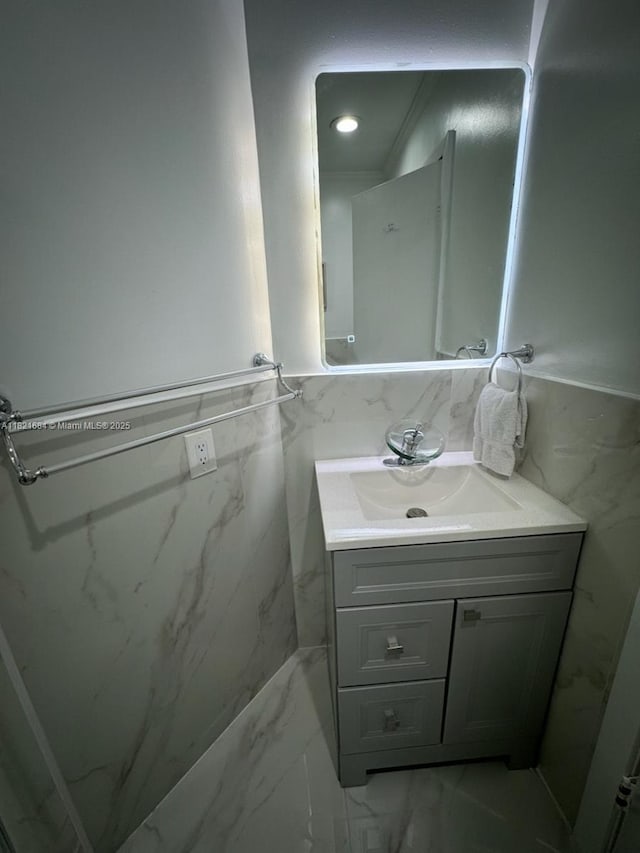 6315 SW 138th Ct Unit 6315-4, Miami, FL 33183 - bathroom with marble look tile flooring, vanity, wainscoting, and tile walls