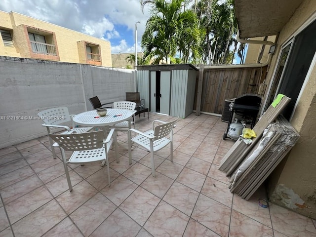 6315 SW 138th Ct Unit 6315-4, Miami, FL 33183 - fenced backyard featuring a storage unit, a patio, outdoor dining space, and grilling area