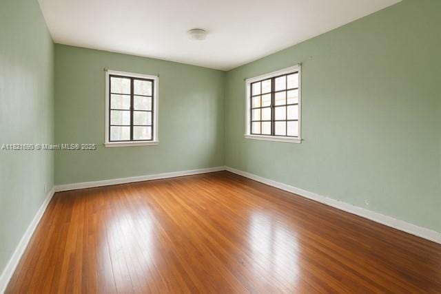5959 SW 16th Ter, West Miami, FL 33155 - empty room featuring wood finished floors and baseboards