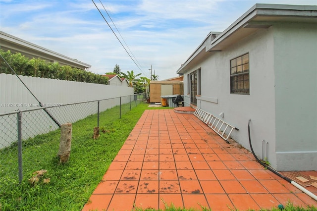 5959 SW 16th Ter, West Miami, FL 33155 - fenced backyard featuring a patio area and a storage unit