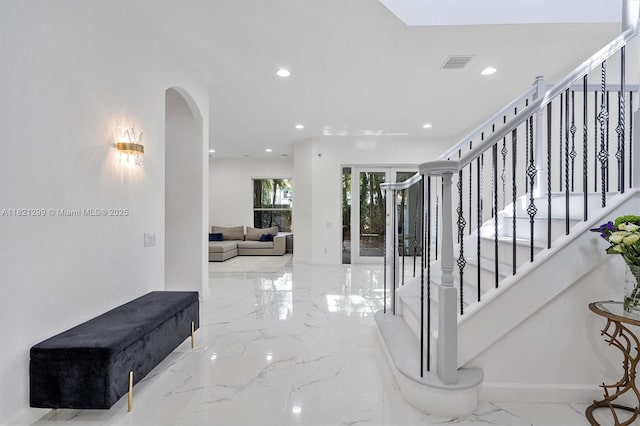 1382 Harbor Vw W, Hollywood, FL 33019 - corridor featuring marble tiled floors, arched walkways, recessed lighting, and stairs