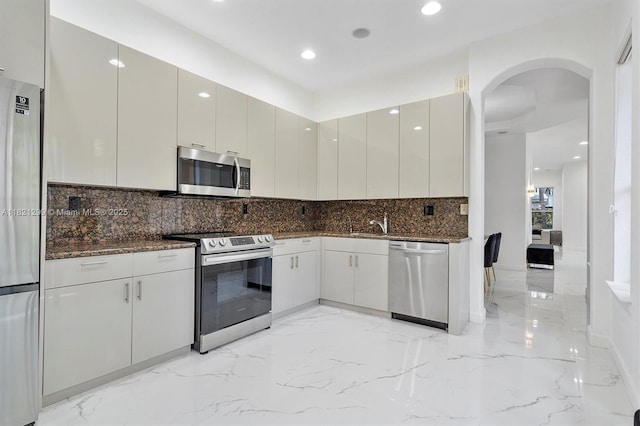 1382 Harbor Vw W, Hollywood, FL 33019 - kitchen with stainless steel appliances, light marble finish floors, arched walkways, backsplash, and recessed lighting