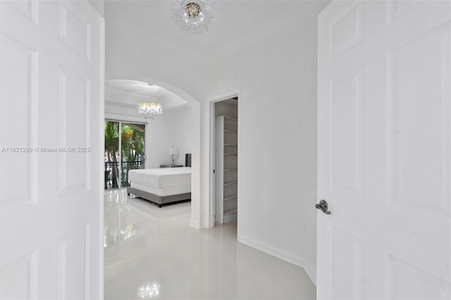 1382 Harbor Vw W, Hollywood, FL 33019 - corridor featuring a chandelier, tile patterned floors, and arched walkways