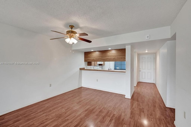 1520 Whitehall Dr Unit 103, Davie, FL 33324 - unfurnished living room featuring wood finished floors, a ceiling fan, a textured ceiling, and recessed lighting