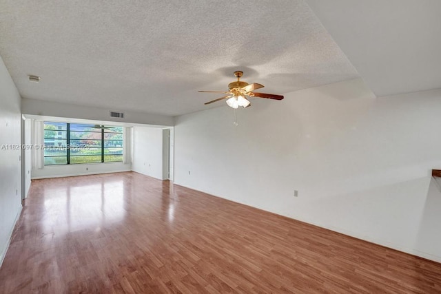 1520 Whitehall Dr Unit 103, Davie, FL 33324 - spare room featuring wood finished floors, a ceiling fan, and a textured ceiling