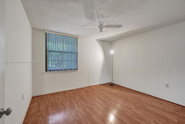 1520 Whitehall Dr Unit 103, Davie, FL 33324 - spare room featuring wood finished floors, ceiling fan, and a textured ceiling