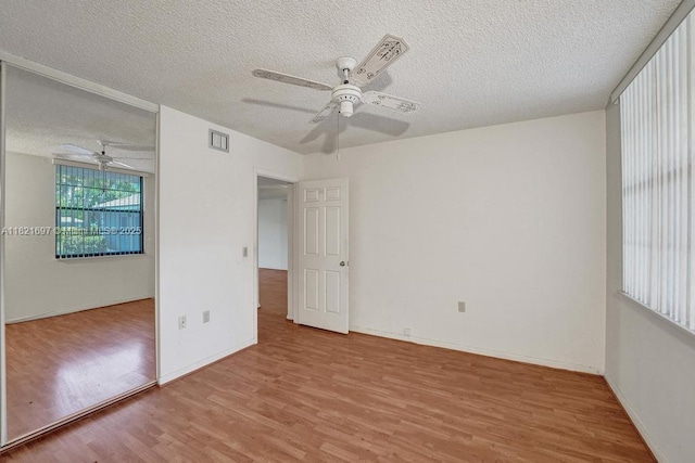1520 Whitehall Dr Unit 103, Davie, FL 33324 - spare room featuring ceiling fan, wood finished floors, and a textured ceiling
