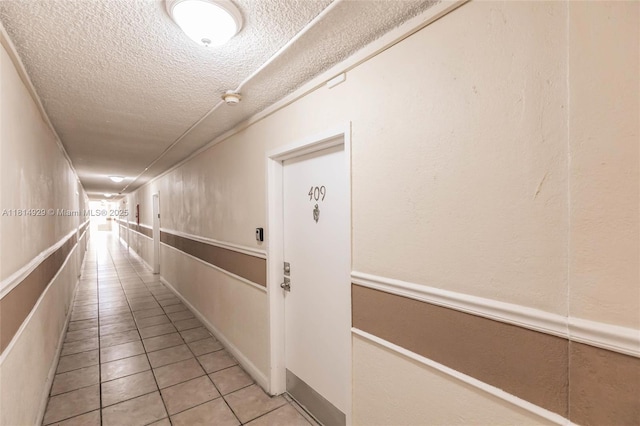 801 NW 47th Ave Unit 409W, Miami, FL 33126 - corridor featuring a textured ceiling and tile patterned floors