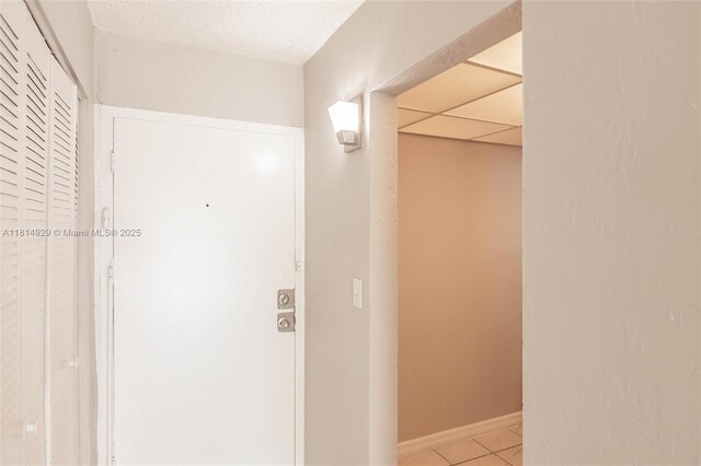 801 NW 47th Ave Unit 409W, Miami, FL 33126 - hallway with light tile patterned floors and baseboards