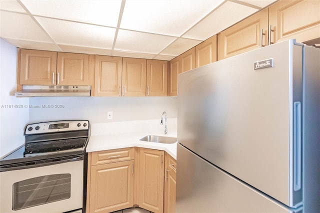 801 NW 47th Ave Unit 409W, Miami, FL 33126 - kitchen with appliances with stainless steel finishes, under cabinet range hood, light brown cabinets, light countertops, and a paneled ceiling