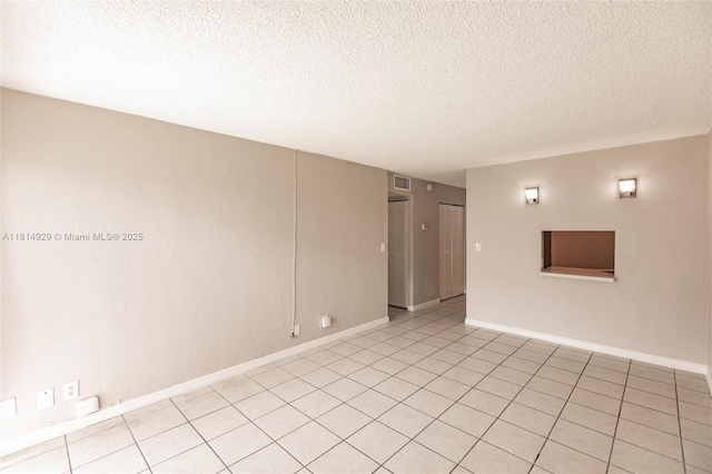 801 NW 47th Ave Unit 409W, Miami, FL 33126 - empty room featuring a textured ceiling and light tile patterned floors