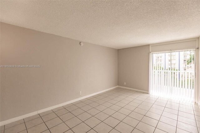 801 NW 47th Ave Unit 409W, Miami, FL 33126 - empty room featuring light tile patterned floors and a textured ceiling