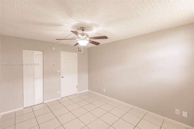 801 NW 47th Ave Unit 409W, Miami, FL 33126 - empty room with a ceiling fan, a textured ceiling, and light tile patterned floors