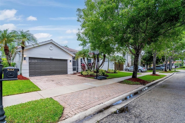 542 Penta Ct, Weston, FL 33327 - view of front of home with decorative driveway, stucco siding, an attached garage, and a front lawn