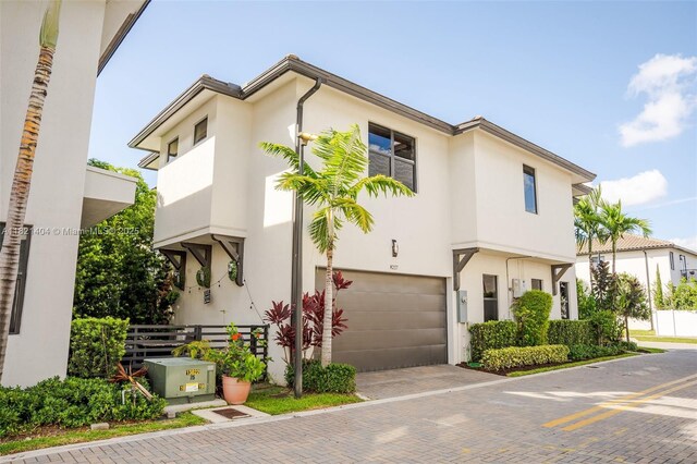8217 NW 46th St, Doral, FL 33166 - townhome / multi-family property with a garage, stucco siding, and decorative driveway