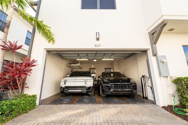 8217 NW 46th St, Doral, FL 33166 - garage with decorative driveway and a garage door opener