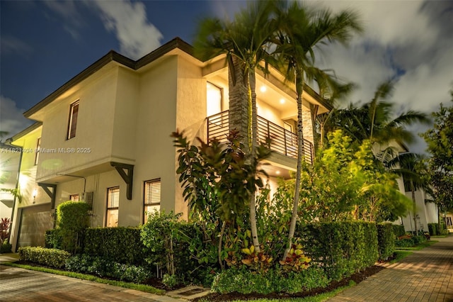 8217 NW 46th St, Doral, FL 33166 - property exterior at twilight featuring stucco siding and a balcony