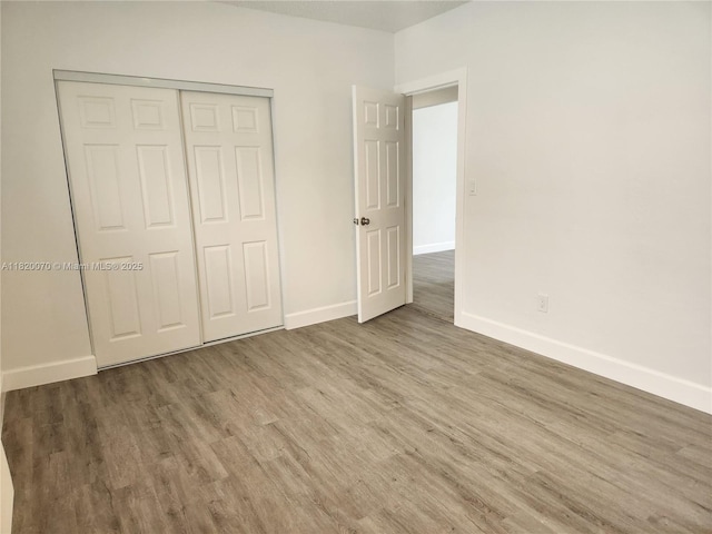 1239 Marseille Dr Unit 4, Miami Beach, FL 33141 - unfurnished bedroom with wood finished floors and a closet