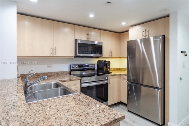 111 E Flagler St Unit 1309, Miami, FL 33131 - kitchen featuring stainless steel appliances, light brown cabinetry, light wood-style flooring, light stone countertops, and recessed lighting