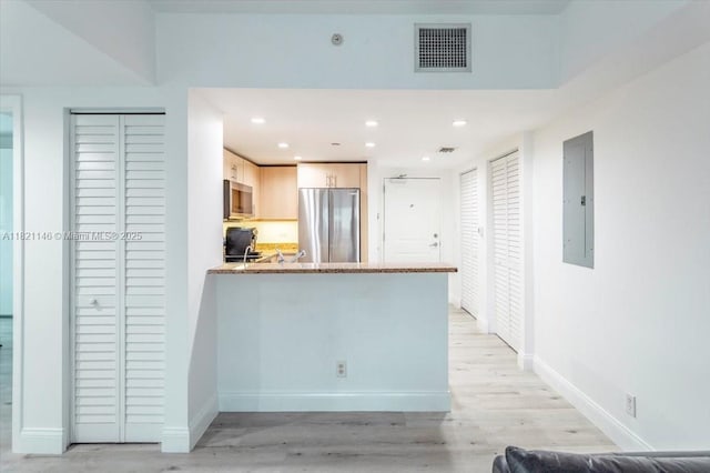 111 E Flagler St Unit 1309, Miami, FL 33131 - kitchen with stainless steel appliances, light wood-style floors, electric panel, a peninsula, and recessed lighting