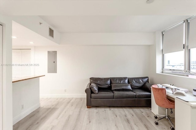 111 E Flagler St Unit 1309, Miami, FL 33131 - living room featuring light wood finished floors, electric panel, and an office area