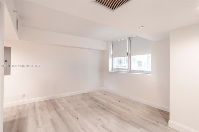 111 E Flagler St Unit 1309, Miami, FL 33131 - spare room with electric panel and wood finished floors
