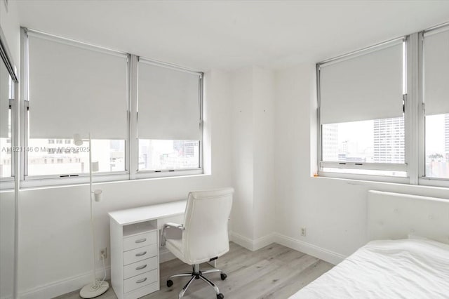 111 E Flagler St Unit 1309, Miami, FL 33131 - bedroom with light wood-style floors and a desk