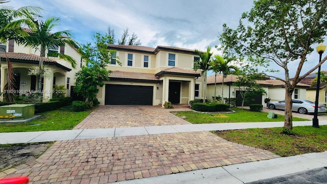 2190 SE 2nd St, Homestead, FL 33033 - mediterranean / spanish-style home featuring decorative driveway, a tiled roof, stucco siding, a garage, and a front lawn