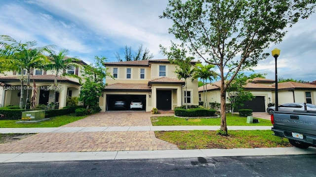 2190 SE 2nd St, Homestead, FL 33033 - mediterranean / spanish house with a tiled roof, decorative driveway, stucco siding, a garage, and a front yard