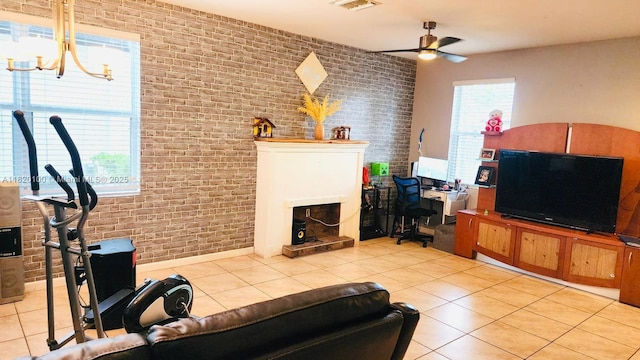 2190 SE 2nd St, Homestead, FL 33033 - living room with brick wall, a ceiling fan, light tile patterned floors, a chandelier, and a fireplace
