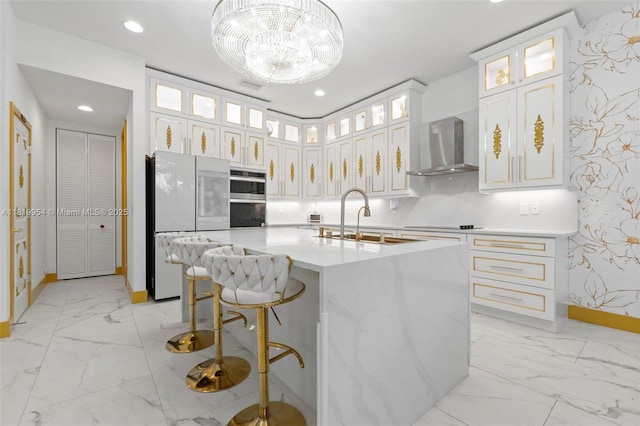 13005 Addilyn Ct, Davie, FL 33325 - kitchen featuring wall chimney exhaust hood, freestanding refrigerator, light marble finish flooring, light countertops, and an island with sink