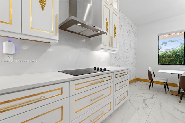 13005 Addilyn Ct, Davie, FL 33325 - kitchen with wall chimney range hood, black electric stovetop, light marble finish floors, white cabinetry, and light stone counters